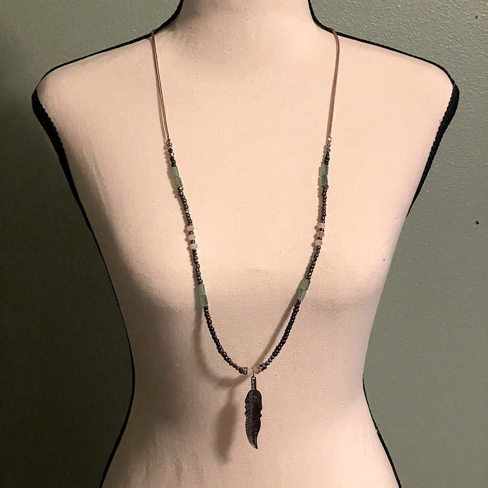 Gold Colored Leaf Pendant Long Necklace with Gold and Teal Bead Detail.